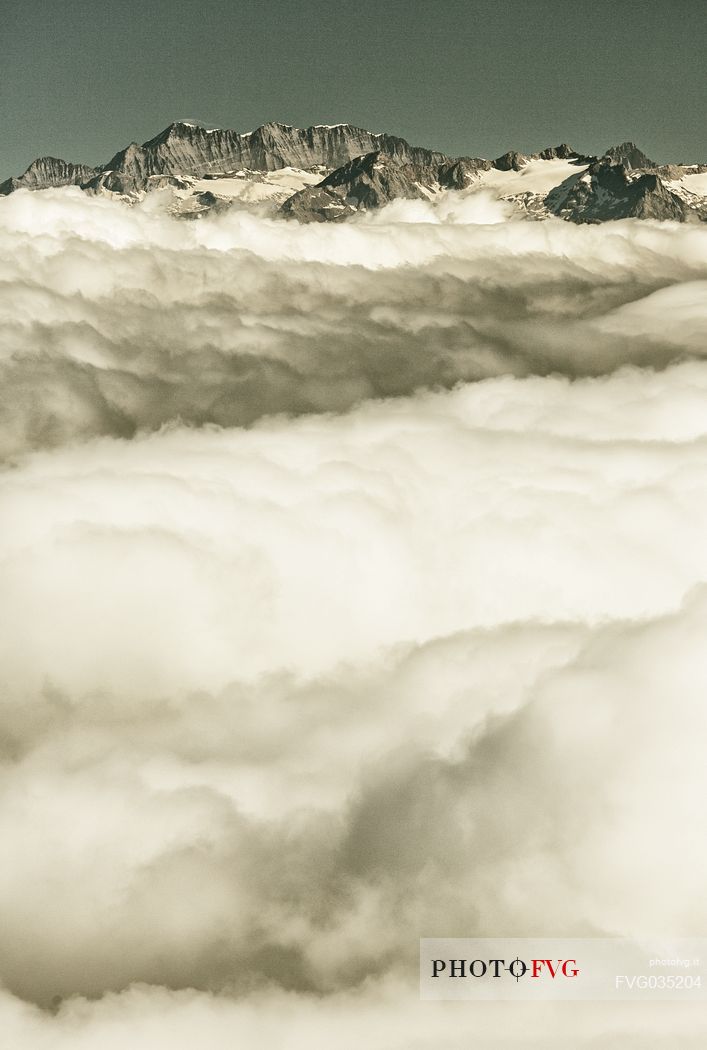 View from Gornergrat mountain towards the mountain of Zermatt valley in the fog, Zermatt, Valais, Switzerland, Europe
 