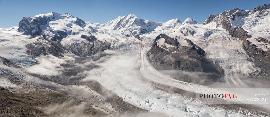 View from Gornergrat mountain towards Monte Rosa or Breithorn mountain range with Liskamm and Gorner Glacier in the clouds, Zermatt, Valais, Switzerland, Europe
 