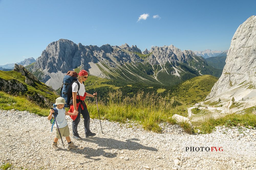 Mother and child walking in Sesis valley, Sappada, dolomites, Friuli Venezia Giulia, Italy, Europe