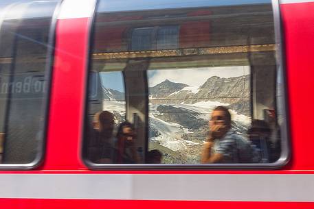Tourists on the Bernina Express admiring the mountains and the glacier at the Bernina pass, Rhetic railways, Engadin, Canton of Grisons, Switzerland, Europe
