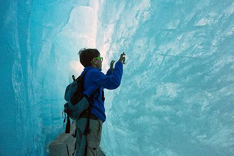 Child inside the Rhone glacier, Furka pass, Valais, Switzerland, Europe