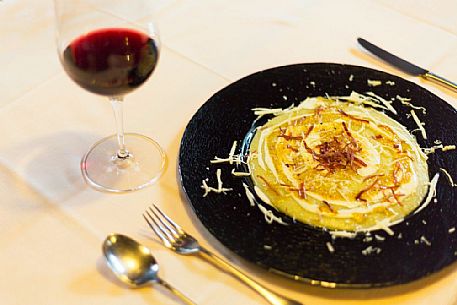 Polenta with cheese and crispy speck Sauris a typical dish served at the restaurant alla Pace of Sauris