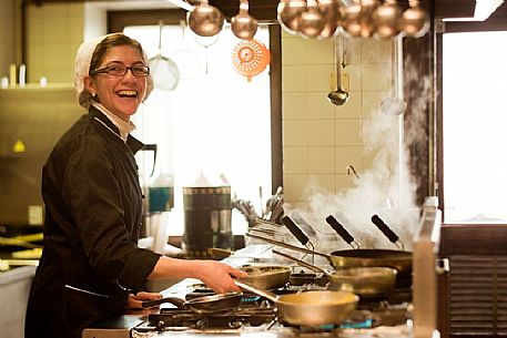 Chef working in the kitchen of Morgenleit restaurant, Sauris