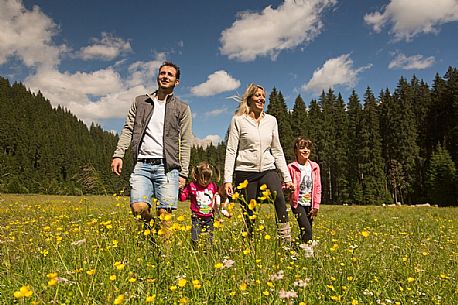 A family walks in Val Visdende, dolomites, Italy