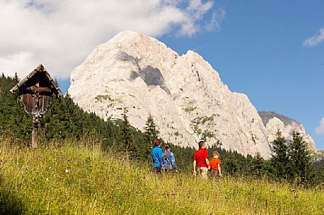 A family walks in Val Visdende, dolomites, Italy