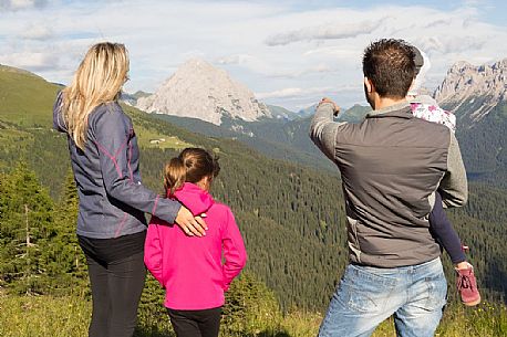 A family walks in Val Visdende, Comelico, Italy