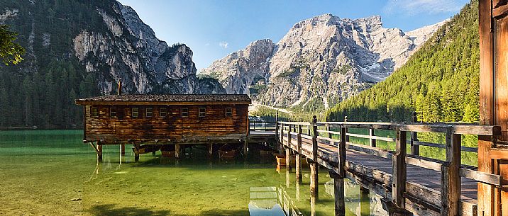 Palafitte on Braies Lake (Pragser Wildsee) and in the background Croda del Becco mountain (Seekofel), Dolomites, South Tyrol, Italy 