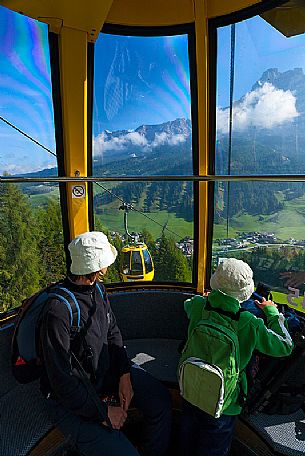 Tourists on gondola-lift to Piz Sorega - Pralongi, Badia Valley, South Tyrol, Dolomites, Italy 