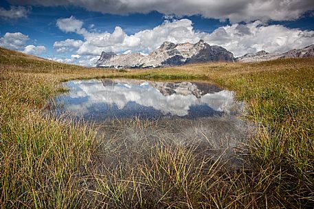 Lake in Pralongi in background the Sasso della Croce mountain, Val Badia, Dolomites, South Tyrol, Italy 