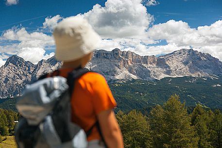 Little hiker admires the Sasso della Croce mountain, Val Badia, dolomites, italy