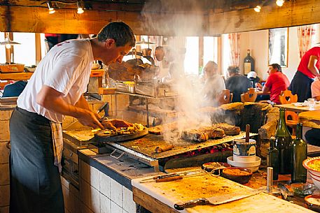 Barbecue in Scotoni hut, Badia Valley, South Tyrol, Dolomites, Italy