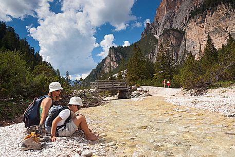 Enjoying with water of a stream, Badia Valley, South Tyrol, Dolomites, Italy 