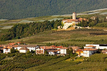 Castel Valer castle and the village in the apple trees valley, Val di Non, Trentino, Italy