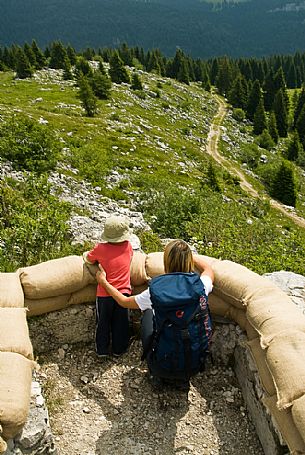 Tourists in the trenches at open-air museum of the Great War on Monte Zebio, Asiago, Italy