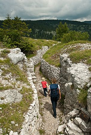 Walking among the trenches of the open-air museum of the Great War, Monte Zebio mountain, Asiago, Italy