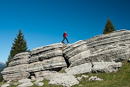 Hiker in the mount Fior, the rocky garden of Asiago plateau, Asiago, Italy