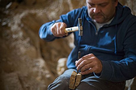 Massimo Cerato is working in the fossil bed of Pesciara in Bolca, Lessini mountain, Italy