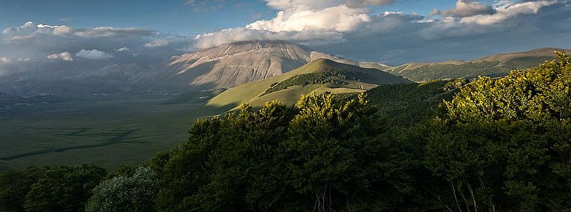 Last lights on Piano Grande Plateau with visible the karst Fosso dei Mergani and in the background Vettore Mount and its fault, Sibillini National Park, Italy