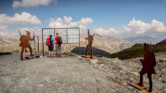 Hikers at Garibaldi peak or Dreisprachenspitze, in the background the swiss alps, Stelvio pass, Stelvio national park, Italy