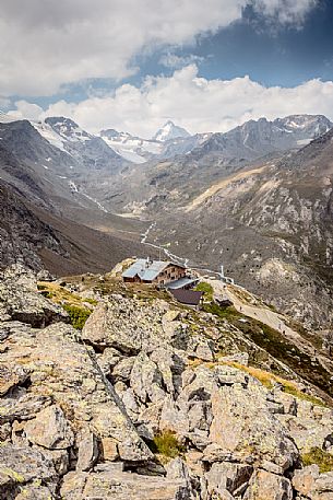 Martello hut and in the background the glacier of Cevedale mount and Gran Zebr peak, Stelvio national park, Italy