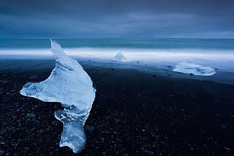 Blue iceberg on black volcanic beach, Jokulsarlon lagoon, Iceland
