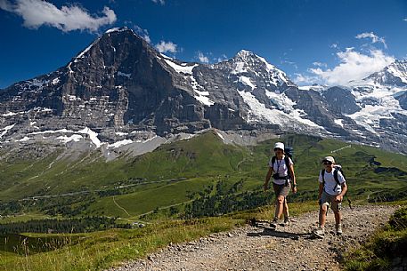 Mother and child in the path from Kleine Scheidegg to Mnnlichen, in front the famous north face of Eiger mount and the Jungfrau mountain group, Grindelwald, Berner Oberland, Switzerland, Europe
 