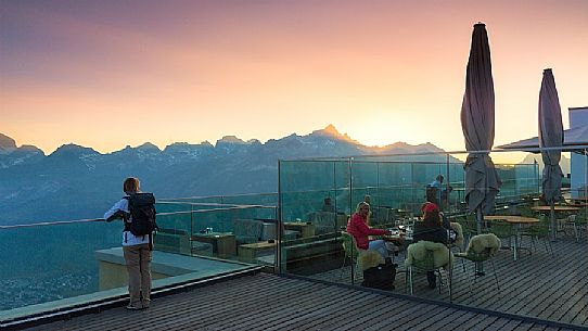 Young woman looking the valley of Saint Moritz at dusk from Romantik Hotel, Muottas Muragl, Samedan, Engadin, Canton of Grisons, Switzerland, Europa