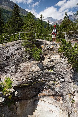 Tourist visiting the Cavaglia Glacial Garden  also referred to as Giants Pots, Cavaglia, Poschiavo valley, Engadin, Canton of Grisons, Switzerland, Europe