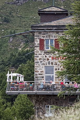 Tourists at the restaurant of the Alp Grum railway station, Rhaetian Railway, Poschiavo valley, Engadin, Canton of Grisons, Switzerland, Europe
