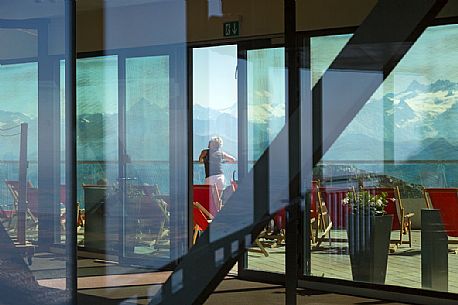 Tourist looking the panorama of mountains of the Bernese Oberland from summit station of Pilatus Cogwheel Railway , Lucerne, Border Area between the Cantons of Lucerne, Nidwalden and Obwalden, Switzerland, Europe