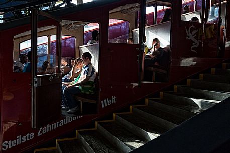 Tourists inside the Cogwheel Railway of Pilatus Mount, Border Area between the Cantons of Lucerne, Nidwalden and Obwalden, Switzerland, Europe