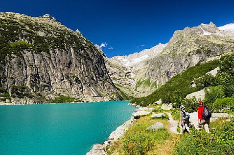 Hiking at the Gelmer lake, Gelmersee, a hydroelectric reservoir, Canton of Berne, Switzerland, Europe