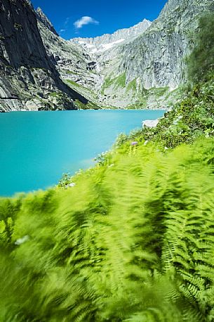 Stacked stones in the shore of Gelmer lake, Gelmersee, a hydroelectric reservoir, Canton of Berne, Switzerland, Europe