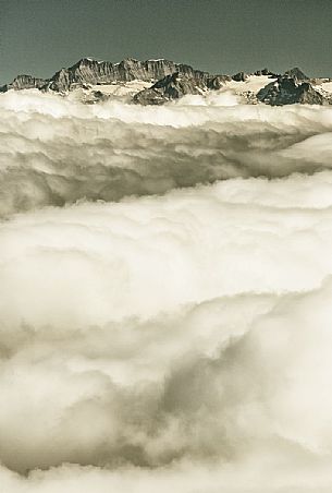 View from Gornergrat mountain towards the mountain of Zermatt valley in the fog, Zermatt, Valais, Switzerland, Europe
 
