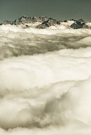 View from Gornergrat mountain towards the mountain of Zermatt valley in the fog, Zermatt, Valais, Switzerland, Europe
 