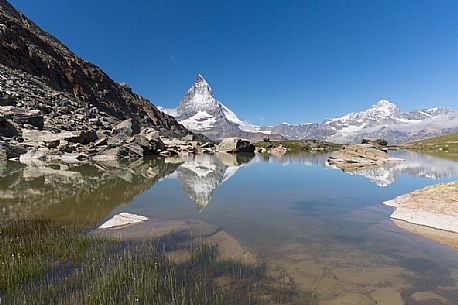 The Matterhorn or Cervino mount reflected in the Riffelsee Lake (Riffel lake), Gornergrat, Zermatt, Valais, Switzerland, Europe
 