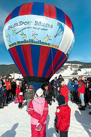 Children admiring the Hot air balloon during the balloons festival in Pusteria valley, Dobbiaco, dolomites, Trentino Alto Adige, Italy, Europe