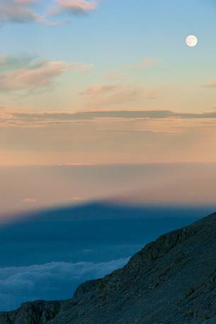 The moon rise in the slope of the amphitheater of the Murelle, Majella national park, Abruzzo, Italy, Europe