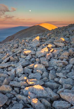 Moon and sunrise at the Mount Acquaviva in the amphitheater of the Murelle, Majella national park, Abruzzo, Italy, Europe