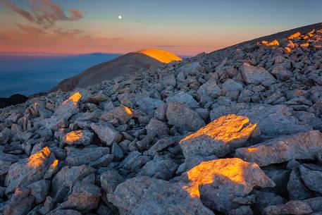 Moon and sunrise at the Mount Acquaviva in the amphitheater of the Murelle, Majella national park, Abruzzo, Italy, Europe