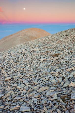 The moon rise over the Mount Acquaviva in the amphitheater of the Murelle, Majella national park, Abruzzo, Italy, Europe