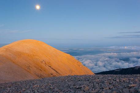 The moon rise over the Mount Acquaviva in the amphitheater of the Murelle, Majella national park, Abruzzo, Italy, Europe