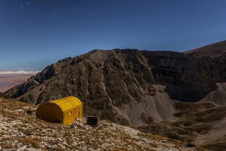 Carlo Fusco hut and the amphitheater of the Murelle at moonlight, Majella national park, Abruzzo, Italy, Europe