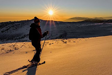 Hiking with snowshoe on the top of Pizzoc mount, Cansiglio plateau, Veneto, Italy, Europe