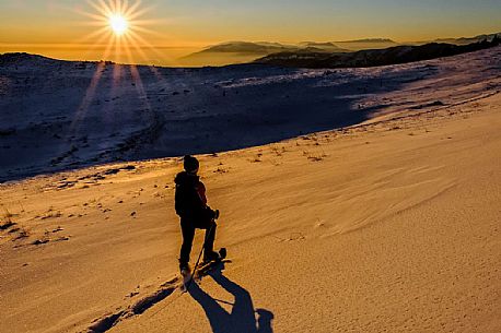 Hiking with snowshoe on the top of Pizzoc mount, Cansiglio plateau, Veneto, Italy, Europe