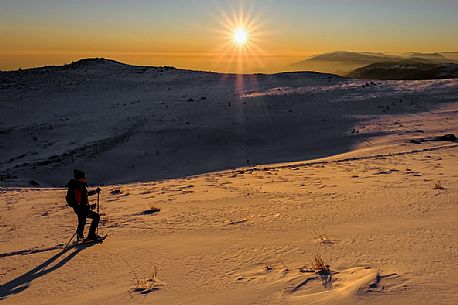 Hiking with snowshoe on the top of Pizzoc mount, Cansiglio plateau, Veneto, Italy, Europe