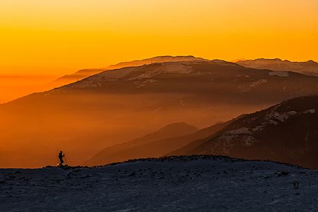 Hiking with snowshoe on the top of Pizzoc mount and in the background the Col Visentin, Cansiglio plateau, Veneto, Italy, Europe