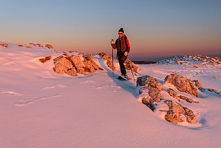 Hiking with snowshoe on the top of Pizzoc mount, Cansiglio plateau, Veneto, Italy, Europe