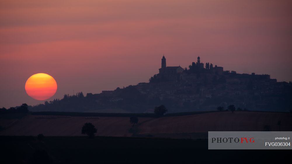 Silhouette of Vignale Monferrato with the clock tower and the castle at sunrise, Monferrato, Piedmont, Italy, Europe