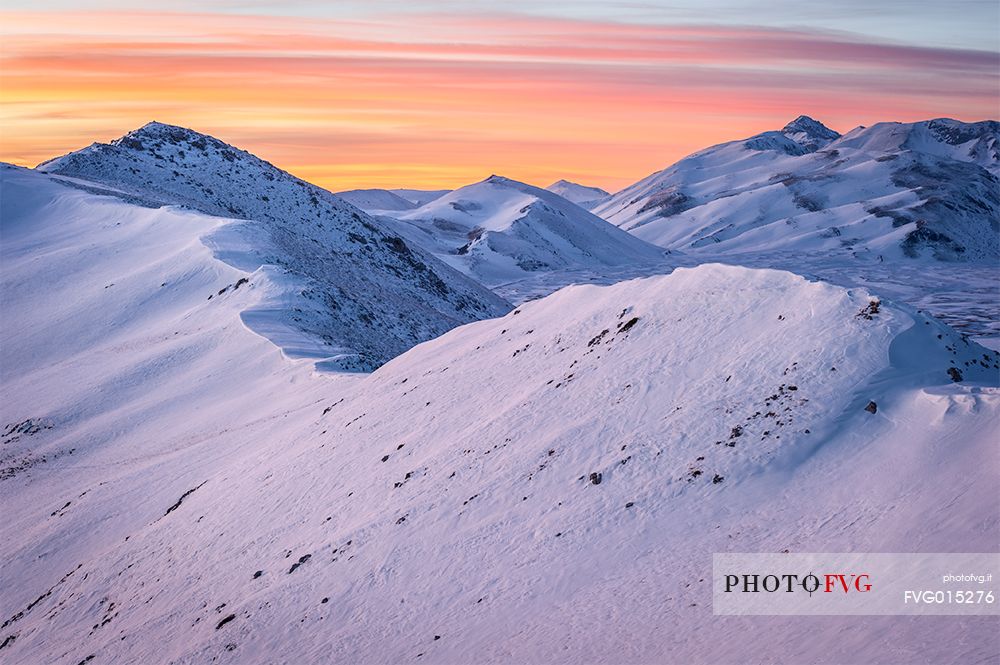 the Mount Bolza's ridge, in Campo Imperatore, during a beautiful coloured sunset 